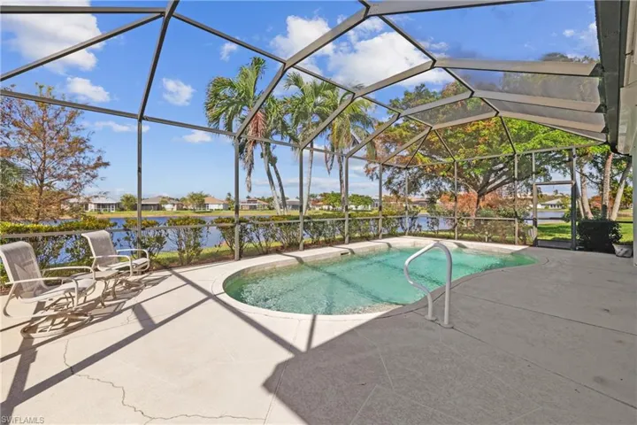 View of pool featuring a screened patio area, lanai, and water view