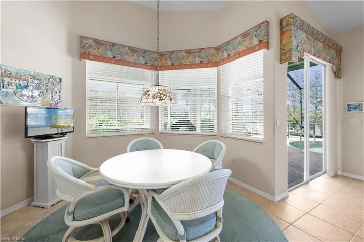 Dining area featuring light tile floors and plenty of natural light