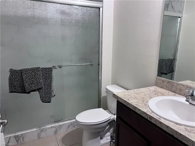 Bathroom featuring vanity and a shower stall