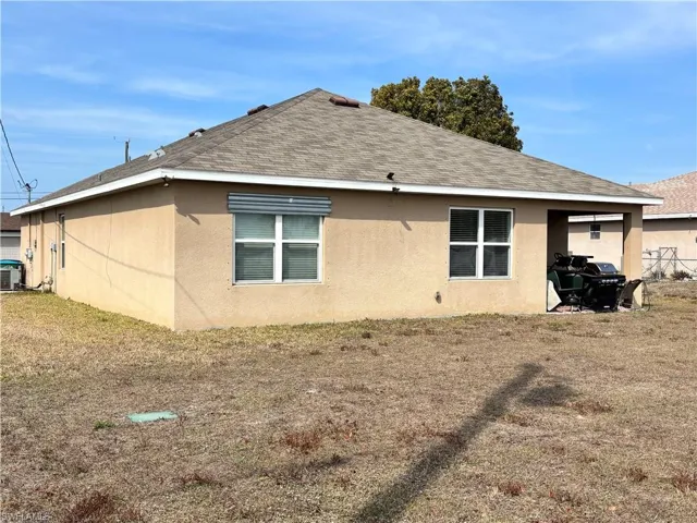 View of home's exterior featuring roof with shingles and stucco siding