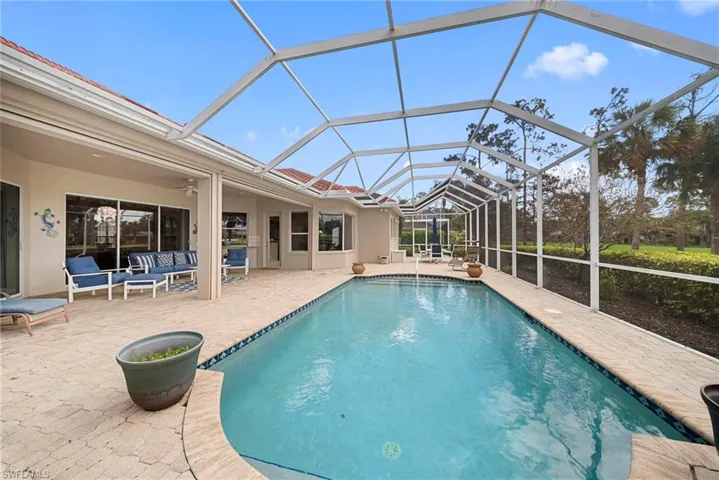 Outdoor pool with a sunroom, a patio area, a lanai, and an outdoor hangout area