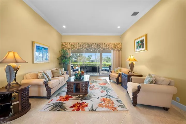 Living room featuring ornamental molding, light tile patterned flooring, and recessed lighting
