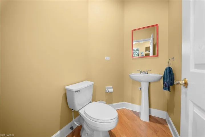 Bathroom featuring toilet and light wood finished floors