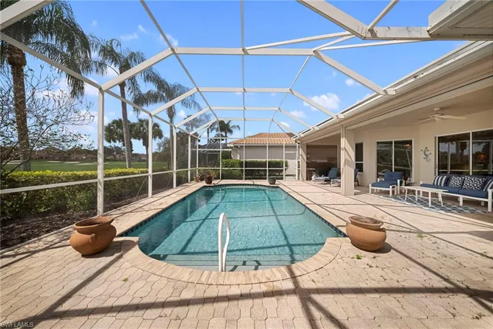 Outdoor pool featuring a patio, a sunroom, a lanai, and outdoor lounge area