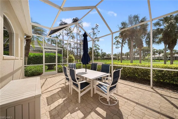 Sunroom / solarium featuring a patio area, outdoor dining space, and healthy amount of natural light