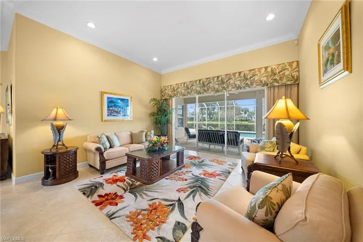 Living room featuring crown molding, tile patterned flooring, a sunroom, and recessed lighting