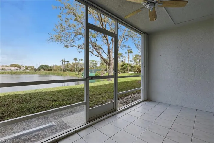Unfurnished sunroom with a water view and ceiling fan