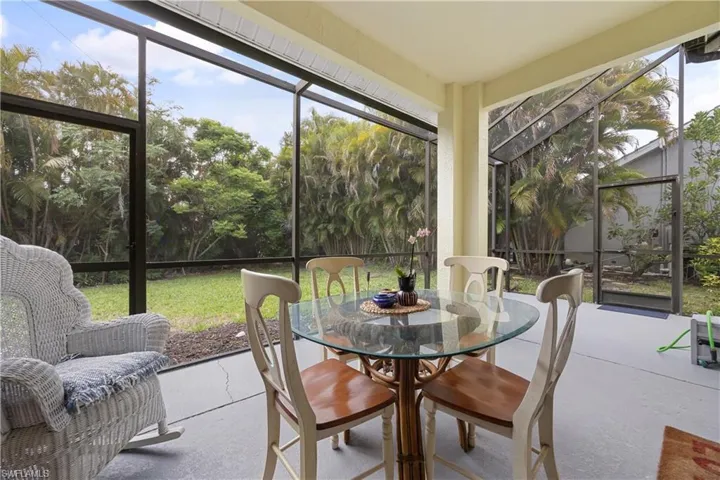 Screened patio featuring concrete flooring, a partial ceiling, and a full-height screened enclosure