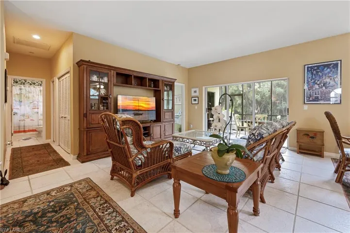 Spacious living area featuring light-toned tile flooring throughout