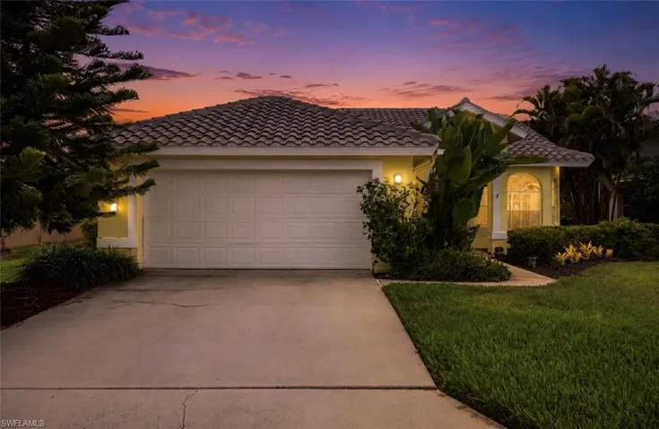 Exterior facade featuring a concrete tile roof, stucco siding, and an attached two-car garage