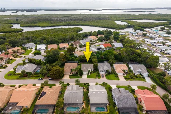 Aerial perspective showcasing a residential street with mature landscaping and diverse roofing materials