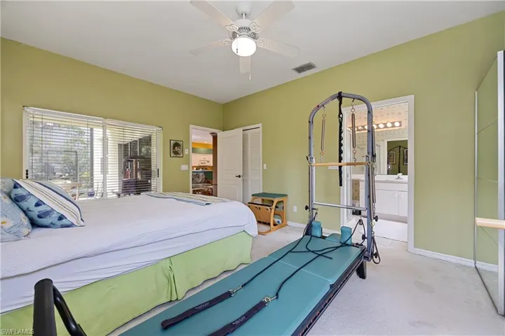 Bedroom featuring light green walls and white ceiling fan with integrated lighting