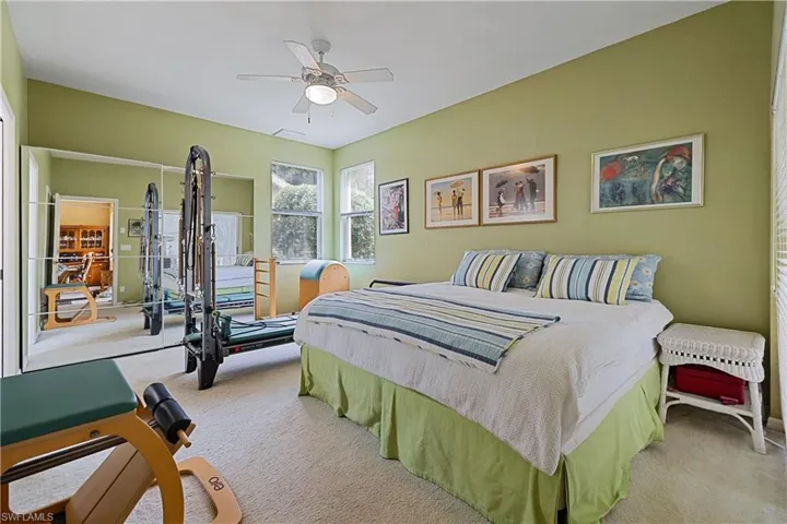 Spacious room featuring light green walls and carpeting