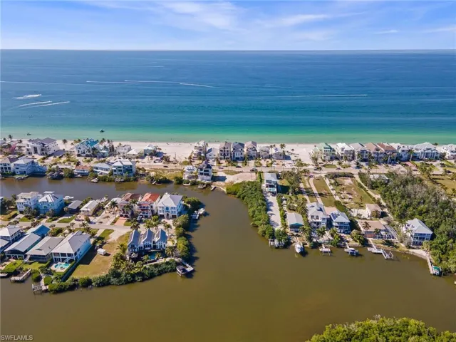 Aerial overview of property's location featuring a nearby body of water and nearby suburban area