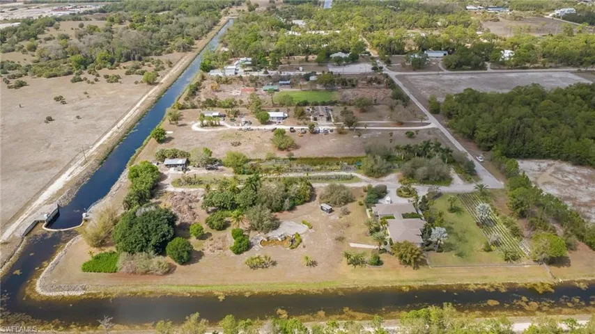 Aerial view of a nearby body of water and a tree filled landscape
