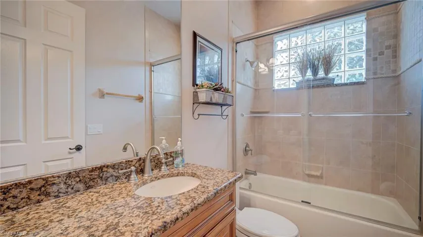 Full bath featuring vanity and enclosed tub / shower combo