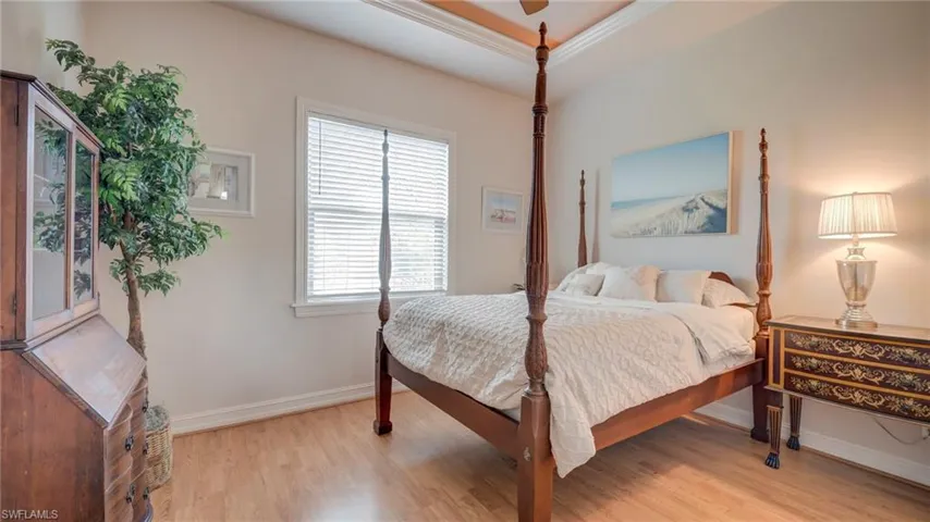 Bedroom featuring light wood finished floors and ornamental molding