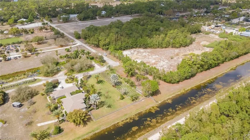 Aerial view of sparsely populated area featuring a tree filled landscape