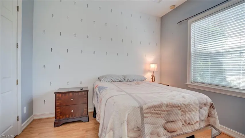 Bedroom with light wood-type flooring and baseboards