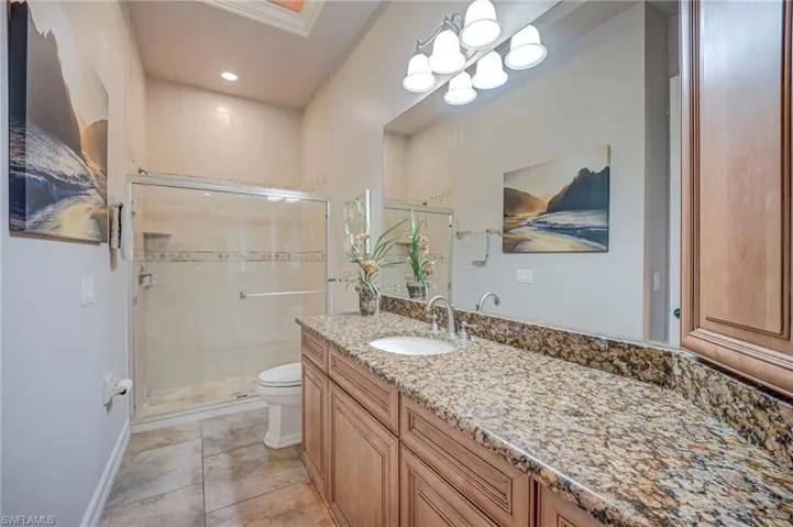 Full bath featuring vanity, a stall shower, and recessed lighting