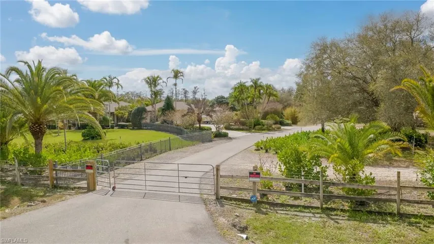 View of estate featuring a gate