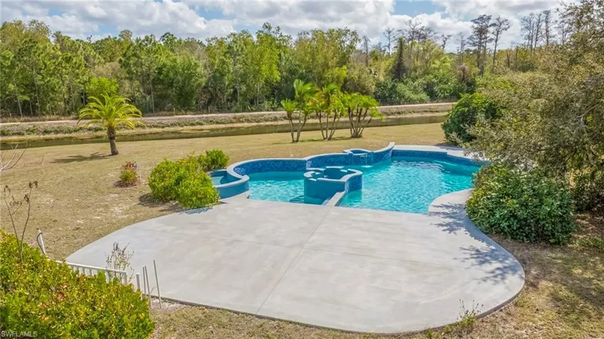 Virtually staged - Integrated pool / spa featuring a yard and a patio area