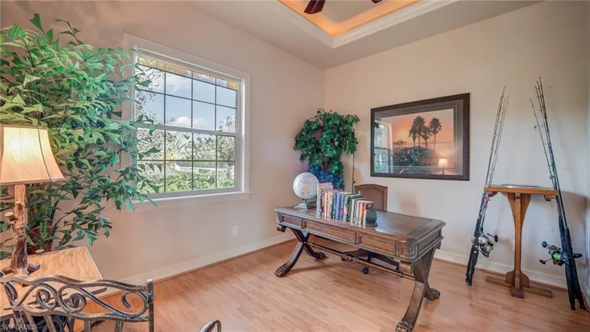 Bedroom being used as office space featuring light wood-style flooring and a ceiling fan