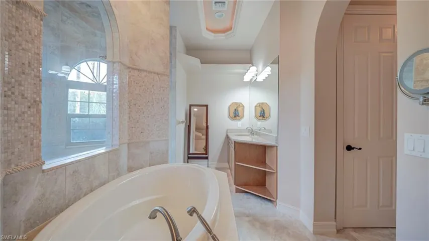 Primary full bathroom with vanity and a garden tub