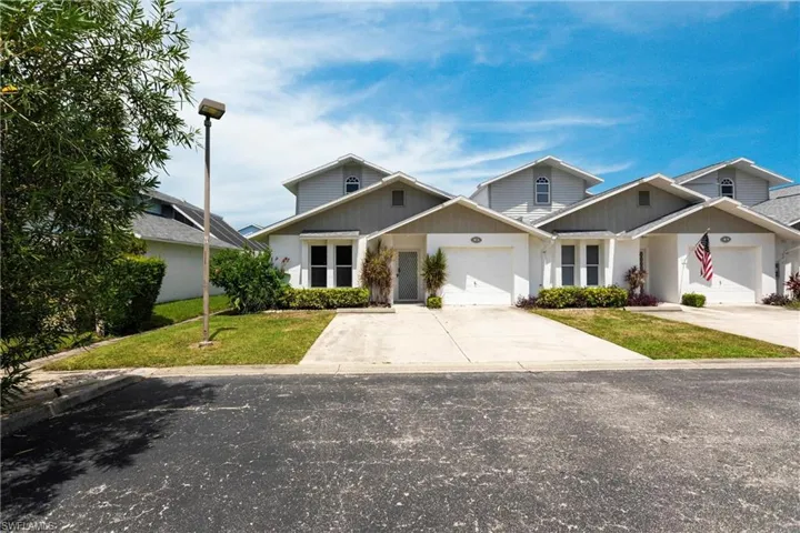 View of front of house featuring a garage and a front yard