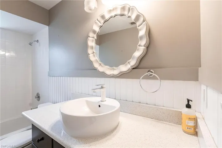 Full bathroom featuring bathtub / shower combination, vanity, and toilet