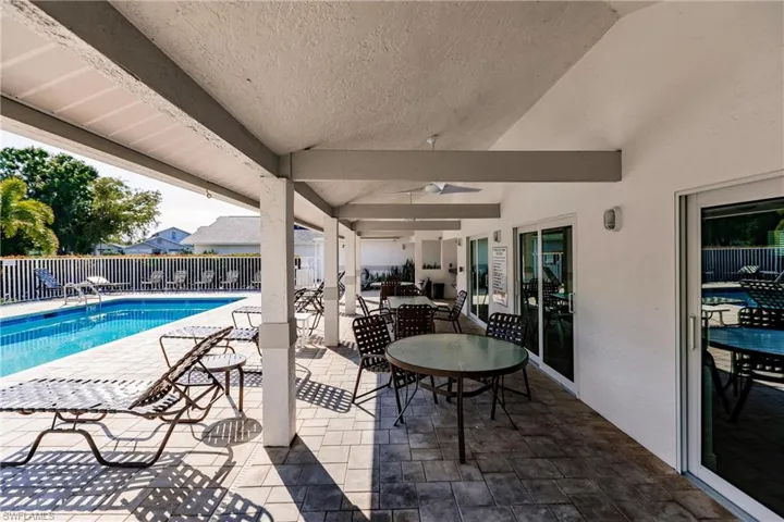 View of swimming pool featuring a patio area and ceiling fan