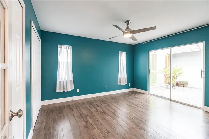 Empty room with wood-type flooring and ceiling fan