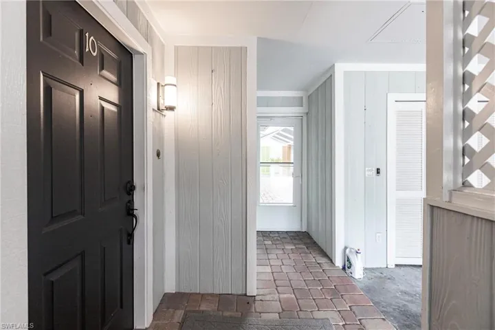Foyer featuring wood walls