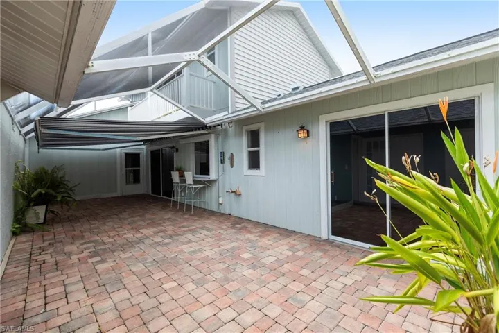 View of patio featuring a lanai