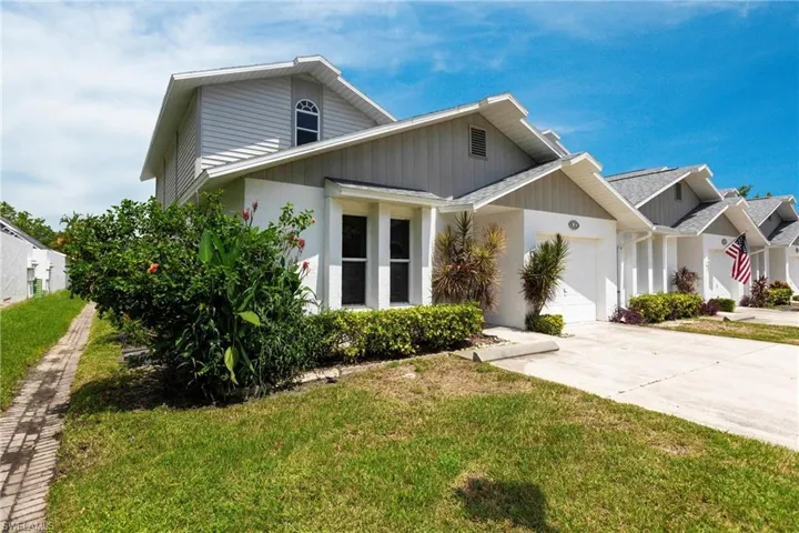 View of front of house featuring a garage and a front lawn