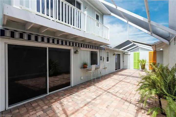 View of patio with a balcony