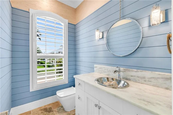 Hallway bath with designer finishes and silver koi sink