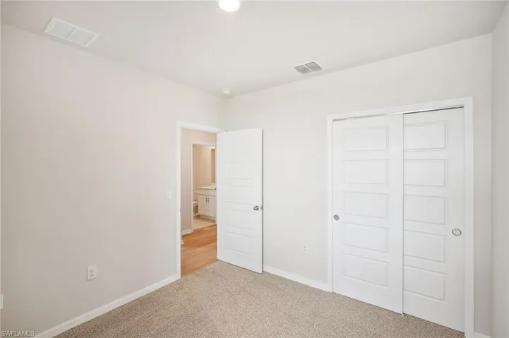 Unfurnished bedroom featuring carpet flooring and a closet