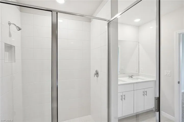 Bathroom featuring vanity and a shower with shower door