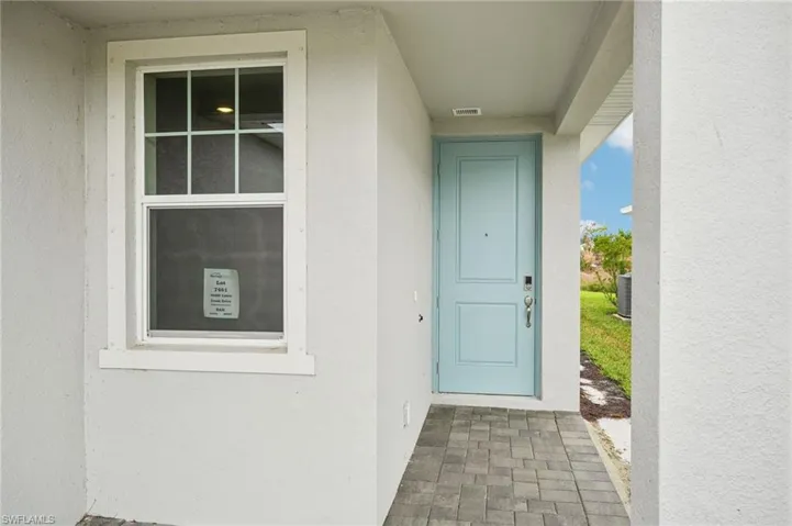 Property entrance featuring central air condition unit