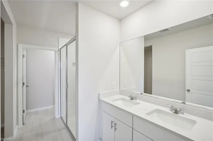 Bathroom with an enclosed shower and vanity