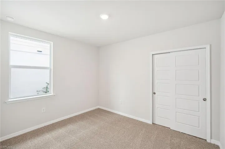 Unfurnished bedroom featuring carpet and a closet