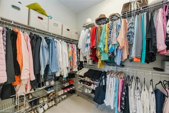 Walk in closet featuring light carpet