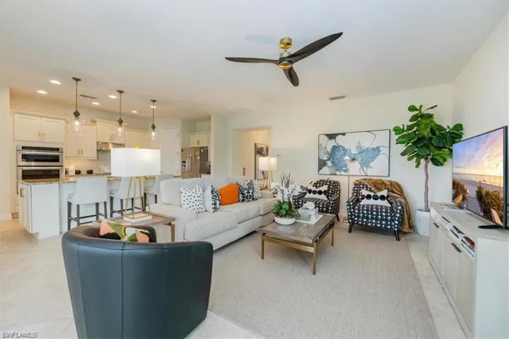 Living room with recessed lighting and a ceiling fan
