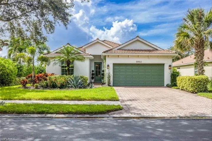View of front facade featuring stucco siding, decorative driveway, a tile roof, a garage, and a front yard