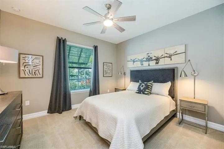 Bedroom featuring light carpet and a ceiling fan