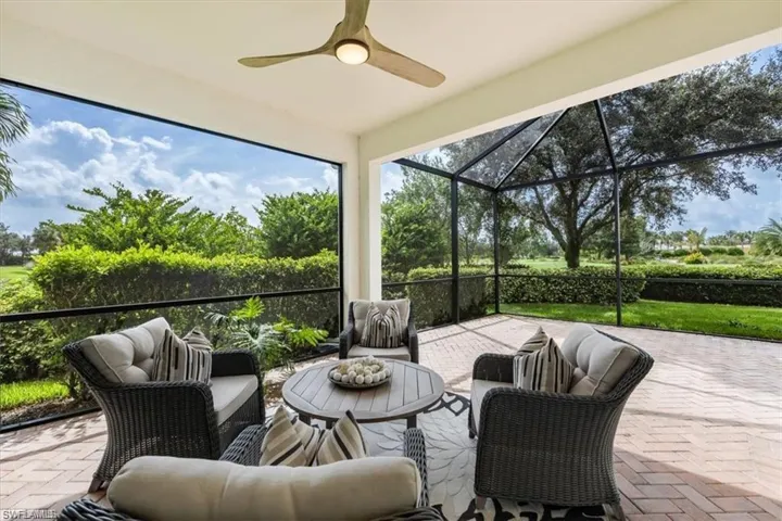 View of patio / terrace with a sunroom, a ceiling fan, a lanai, and an outdoor living space all screened in.