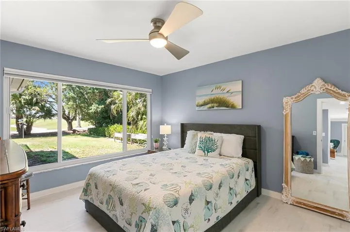 Bedroom with a ceiling fan and baseboards