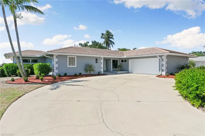 Single story home with stucco siding, concrete driveway, a tile roof, and a garage