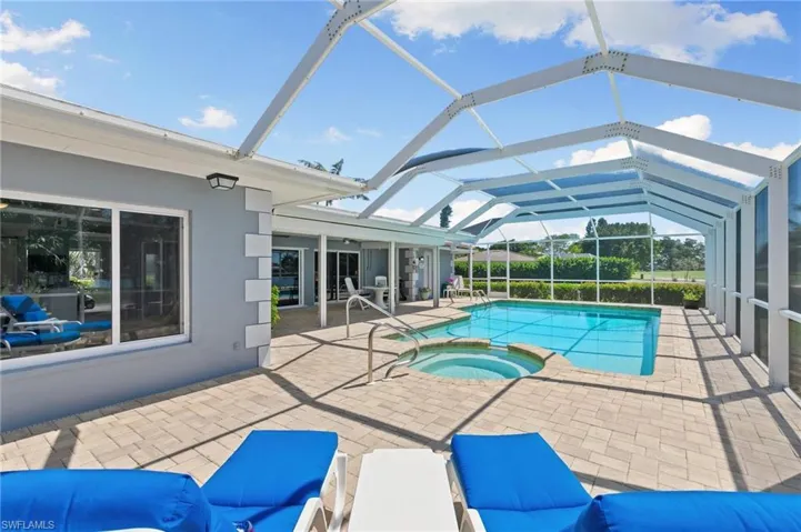 View of pool with a lanai, a patio area, and a pool with connected hot tub